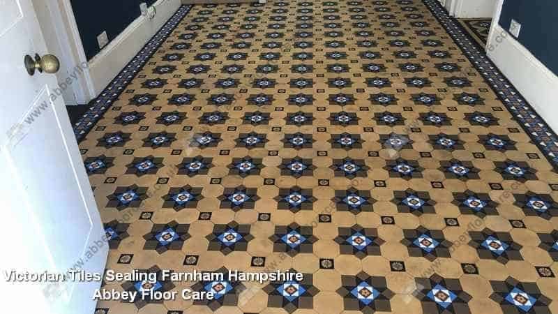 Breathable sealer being applied to cleaned Victorian tiles in Farnham hallway